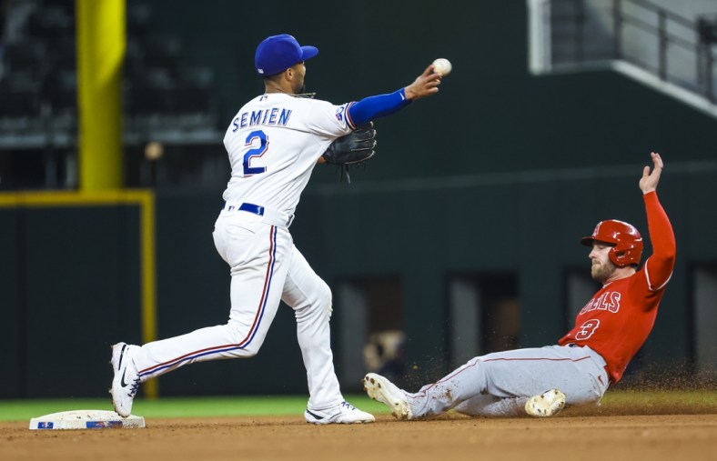 May 16, 2022; Arlington, Texas, USA;  Texas Rangers second baseman Marcus Semien (2) completes a double play over Los Angeles Angels right fielder Taylor Ward (3) during the seventh inning at Globe Life Field. Mandatory Credit: Kevin Jairaj-USA TODAY Sports