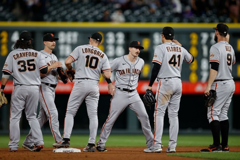 May 16, 2022; Denver, Colorado, USA; San Francisco Giants left fielder Thairo Estrada (39) and center fielder Austin Slater (13) celebrate with shortstop Brandon Crawford (35) and third baseman Evan Longoria (10) and pinch hitter Wilmer Flores (41) and first baseman Brandon Belt (9) after the game against the Colorado Rockies at Coors Field. Mandatory Credit: Isaiah J. Downing-USA TODAY Sports