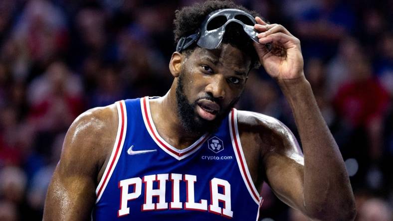 May 12, 2022; Philadelphia, Pennsylvania, USA; Philadelphia 76ers center Joel Embiid (21) removes his mask during a break in actin against the Miami Heat in the second quarter in game six of the second round of the 2022 NBA playoffs at Wells Fargo Center. Mandatory Credit: Bill Streicher-USA TODAY Sports