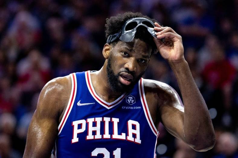 May 12, 2022; Philadelphia, Pennsylvania, USA; Philadelphia 76ers center Joel Embiid (21) removes his mask during a break in actin against the Miami Heat in the second quarter in game six of the second round of the 2022 NBA playoffs at Wells Fargo Center. Mandatory Credit: Bill Streicher-USA TODAY Sports