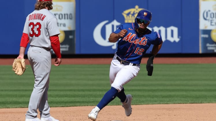 May 17, 2022; New York City, New York, USA; New York Mets shortstop Francisco Lindor (12) rounds second base in front of St. Louis Cardinals third baseman Brendan Donovan (33) during the third inning against the St. Louis Cardinals at Citi Field. Mandatory Credit: Vincent Carchietta-USA TODAY Sports