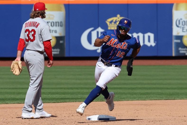 May 17, 2022; New York City, New York, USA; New York Mets shortstop Francisco Lindor (12) rounds second base in front of St. Louis Cardinals third baseman Brendan Donovan (33) during the third inning against the St. Louis Cardinals at Citi Field. Mandatory Credit: Vincent Carchietta-USA TODAY Sports