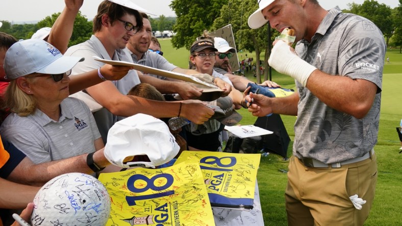 May 17, 2022; Tulsa, Oklahoma, USA; Bryson DeChambeau eats a peanut butter and grape jelly sandwich after his practice round for the PGA Championship golf tournament at Southern Hills Country Club. Mandatory Credit: Michael Madrid-USA TODAY Sports