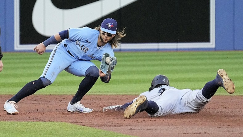 May 17, 2022; Toronto, Ontario, CAN; Seattle Mariners center fielder Julio Rodriguez (44) steals second base as the throw to Toronto Blue Jays shortstop Bo Bichette (11) arrives too late during the second inning at Rogers Centre. Mandatory Credit: John E. Sokolowski-USA TODAY Sports