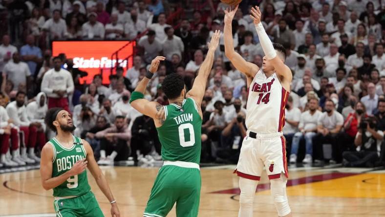 May 17, 2022; Miami, Florida, USA; Miami Heat guard Tyler Herro (14) takes a shot over Boston Celtics forward Jayson Tatum (0) during the first half of game one of the 2022 eastern conference finals at FTX Arena. Mandatory Credit: Jasen Vinlove-USA TODAY Sports