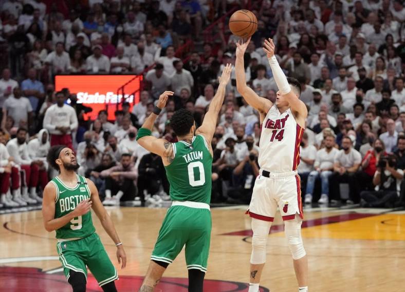 May 17, 2022; Miami, Florida, USA; Miami Heat guard Tyler Herro (14) takes a shot over Boston Celtics forward Jayson Tatum (0) during the first half of game one of the 2022 eastern conference finals at FTX Arena. Mandatory Credit: Jasen Vinlove-USA TODAY Sports