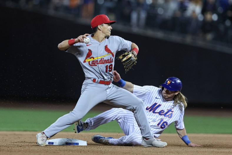 May 17, 2022; New York City, New York, USA; St. Louis Cardinals second baseman Tommy Edman (19) attempts to throw the ball to first base as New York Mets center fielder Travis Jankowski (16) slides in to second base at Citi Field. Mandatory Credit: Vincent Carchietta-USA TODAY Sports