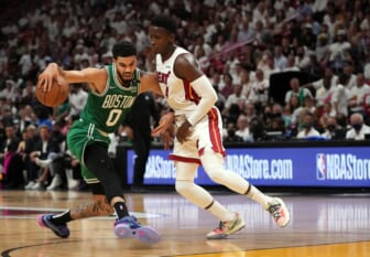 May 17, 2022; Miami, Florida, USA; Boston Celtics forward Jayson Tatum (0) dribbles around Miami Heat guard Tyler Herro (14) during the first half of game one of the 2022 eastern conference finals at FTX Arena. Mandatory Credit: Jasen Vinlove-USA TODAY Sports