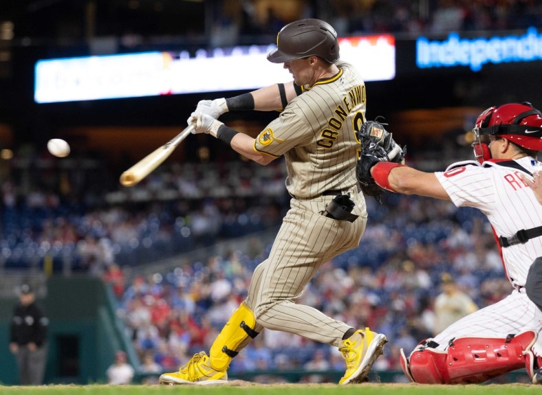 May 17, 2022; Philadelphia, Pennsylvania, USA; San Diego Padres second baseman Jake Cronenworth (9) hits a single during the sixth inning against the Philadelphia Phillies at Citizens Bank Park. Mandatory Credit: Bill Streicher-USA TODAY Sports