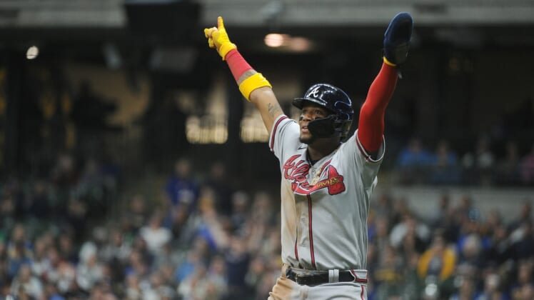 May 17, 2022; Milwaukee, Wisconsin, USA; Atlanta Braves right fielder Ronald Acuna Jr. (13) celebrates the home run of Atlanta Braves left fielder Marcell Ozuna (20) in the eighth inning against the Milwaukee Brewers at American Family Field. Mandatory Credit: Michael McLoone-USA TODAY Sports