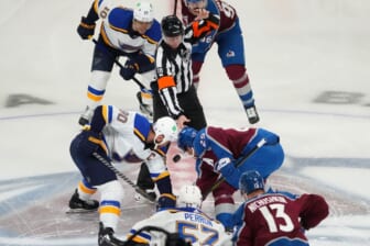 May 17, 2022; Denver, Colorado, USA; NHL referee Chris Lee (28) drops the puck for St. Louis Blues center Ryan O'Reilly (90) and Colorado Avalanche center Nathan MacKinnon (29) in the first period of game one of the second round of the 2022 Stanley Cup Playoffs at Ball Arena. Mandatory Credit: Ron Chenoy-USA TODAY Sports