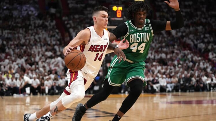 May 17, 2022; Miami, Florida, USA; Miami Heat guard Tyler Herro (14) dribbles up the court against Boston Celtics center Robert Williams III (44) during the second half of game one of the 2022 eastern conference finals at FTX Arena. Mandatory Credit: Jasen Vinlove-USA TODAY Sports