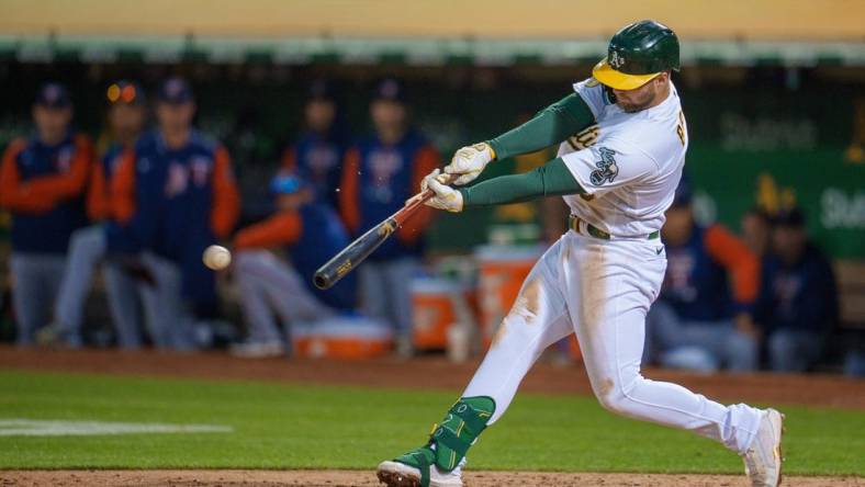 May 17, 2022; Oakland, California, USA; Oakland Athletics first baseman Seth Brown (15) hits a single during the fifth inning against the Minnesota Twins at RingCentral Coliseum. Mandatory Credit: Neville E. Guard-USA TODAY Sports