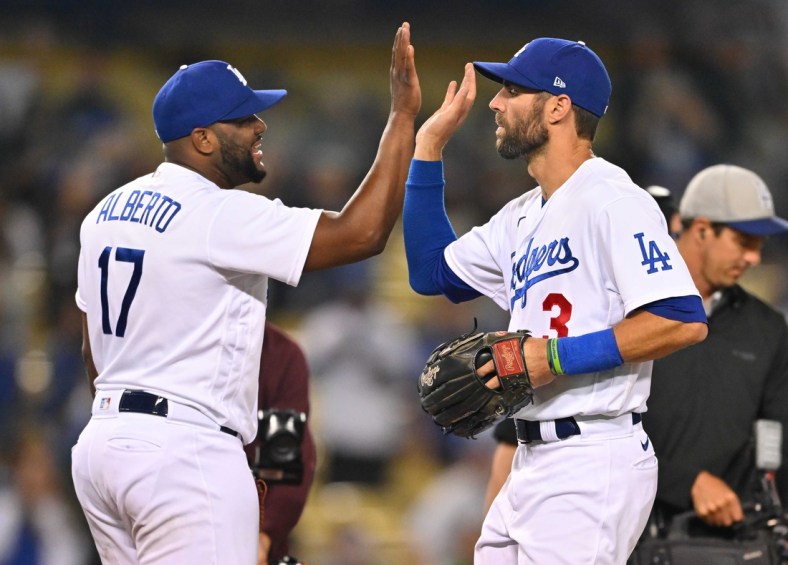 May 17, 2022; Los Angeles, California, USA;  Los Angeles Dodgers second baseman Hanser Alberto (17) gets a high five from left fielder Chris Taylor (3) after pitching the ninth inning against the Arizona Diamondbacks at Dodger Stadium. Mandatory Credit: Jayne Kamin-Oncea-USA TODAY Sports