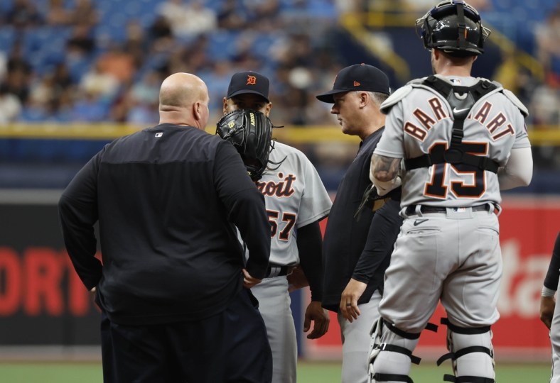 May 18, 2022; St. Petersburg, Florida, USA; Detroit Tigers starting pitcher Eduardo Rodriguez (57) talks with manager A.J. Hinch (14) and trainer as he is taken out of the game during the first inning against the Tampa Bay Rays  at Tropicana Field. Mandatory Credit: Kim Klement-USA TODAY Sports