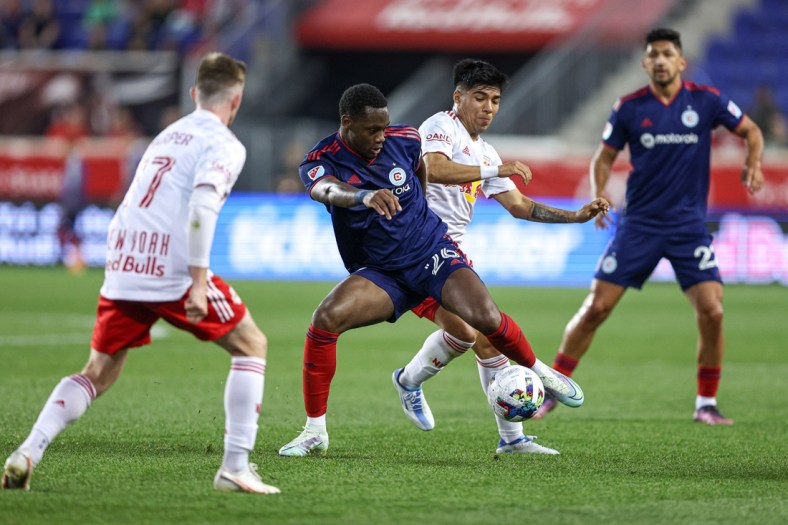 May 18, 2022; Harrison, New Jersey, USA; Chicago Fire forward Jhon Duran (26) plays the ball in front of New York Red Bulls midfielder Omir Fernandez (21) during the first half at Red Bull Arena. Mandatory Credit: Vincent Carchietta-USA TODAY Sports