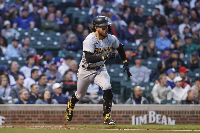 May 18, 2022; Chicago, Illinois, USA; Pittsburgh Pirates second baseman Michael Chavis (2) runs to first base after hitting an RBI-single against the Chicago Cubs during the third inning at Wrigley Field. Mandatory Credit: Kamil Krzaczynski-USA TODAY Sports