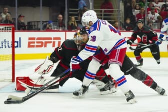 May 18, 2022; Raleigh, North Carolina, USA; New York Rangers center Andrew Copp (18) tries to get the shot away against Carolina Hurricanes defenseman Jaccob Slavin (74) and goaltender Antti Raanta (32) during the second period in game one of the second round of the 2022 Stanley Cup Playoffs at PNC Arena. Mandatory Credit: James Guillory-USA TODAY Sports