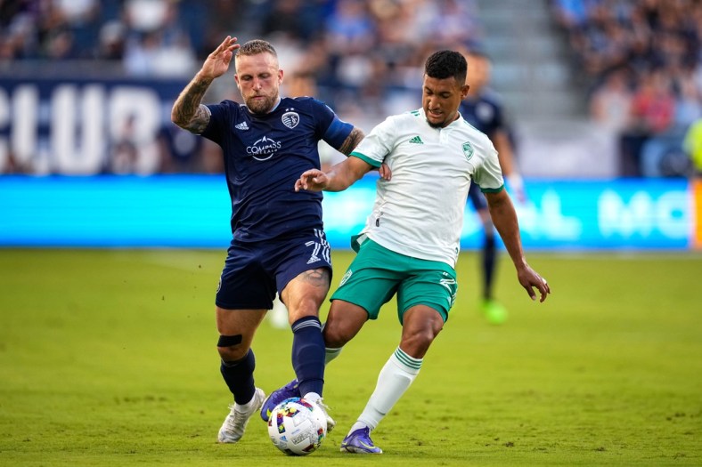 May 18, 2022; Kansas City, Kansas, USA; Sporting Kansas City forward Johnny Russell (7) and Colorado Rapids midfielder Bryan Acosta (21) fight for the ball during the first half at Children's Mercy Park. Mandatory Credit: Jay Biggerstaff-USA TODAY Sports