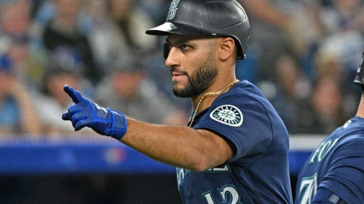 May 18, 2022; Toronto, Ontario, CAN;   Seattle Mariners second baseman Abraham Toro (13) gestures toward the dugout after hitting a solo home run against the Toronto Blue Jays in the ninth inning at Rogers Centre. Mandatory Credit: Dan Hamilton-USA TODAY Sports