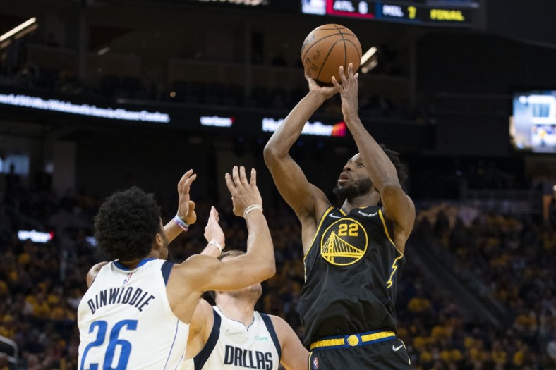 May 18, 2022; San Francisco, California, USA; Golden State Warriors forward Andrew Wiggins (22) shoots the basketball against Dallas Mavericks guard Spencer Dinwiddie (26) during the fourth quarter in game one of the 2022 western conference finals at Chase Center. Mandatory Credit: Kyle Terada-USA TODAY Sports