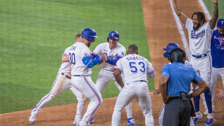 May 18, 2022; Arlington, Texas, USA; Texas Rangers first baseman Nathaniel Lowe (30) celebrates with his teammates after hitting the game winning 2-run home run during the tenth inning against the Los Angeles Angels at Globe Life Field. Mandatory Credit: Andrew Dieb-USA TODAY Sports