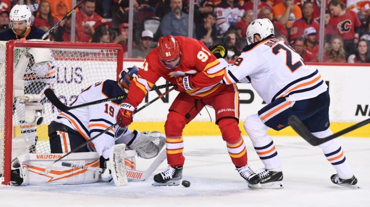 May 18, 2022; Calgary, Alberta, CAN; Edmonton Oilers goalie Mikko Koskinen (19) and forward Leon Draisaitl (29) defend against Calgary Flames forward Calle Jarnkrok (91) during the second period in game one of the second round of the 2022 Stanley Cup Playoffs at Scotiabank Saddledome. Mandatory Credit: Candice Ward-USA TODAY Sports