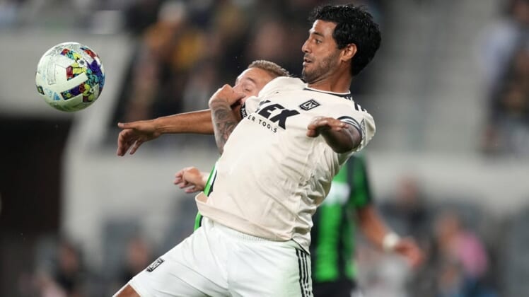 May 18, 2022; Los Angeles, California, USA; LAFC forward Carlos Vela (10) and Austin FC defender   an Kolmani   (23) battle for the ball in the second half at Banc of California Stadium. Mandatory Credit: Kirby Lee-USA TODAY Sports