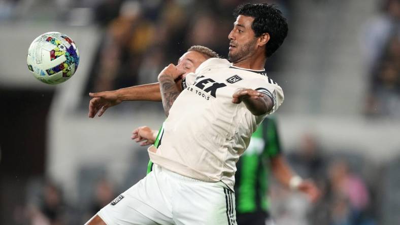 May 18, 2022; Los Angeles, California, USA; LAFC forward Carlos Vela (10) and Austin FC defender   an Kolmani   (23) battle for the ball in the second half at Banc of California Stadium. Mandatory Credit: Kirby Lee-USA TODAY Sports