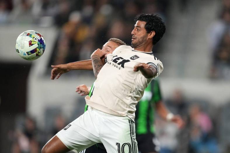 May 18, 2022; Los Angeles, California, USA; LAFC forward Carlos Vela (10) and Austin FC defender   an Kolmani   (23) battle for the ball in the second half at Banc of California Stadium. Mandatory Credit: Kirby Lee-USA TODAY Sports