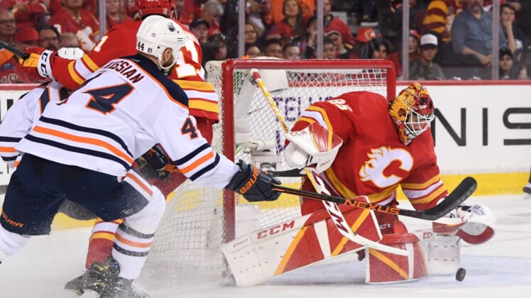 May 18, 2022; Calgary, Alberta, CAN; Calgary Flames goalie Jacob Markstrom (25) stops a shot from the Edmonton Oilers in the third period in game one of the second round of the 2022 Stanley Cup Playoffs at Scotiabank Saddledome. Flames won 9-6. Mandatory Credit: Candice Ward-USA TODAY Sports