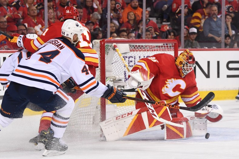 May 18, 2022; Calgary, Alberta, CAN; Calgary Flames goalie Jacob Markstrom (25) stops a shot from the Edmonton Oilers in the third period in game one of the second round of the 2022 Stanley Cup Playoffs at Scotiabank Saddledome. Flames won 9-6. Mandatory Credit: Candice Ward-USA TODAY Sports