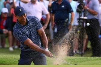 May 19, 2022; Tulsa, Oklahoma, USA; Tiger Woods plays his shot from the bunker on the 13th green during the first round of the PGA Championship golf tournament. Mandatory Credit: Orlando Ramirez-USA TODAY Sports