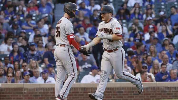 May 19, 2022; Chicago, Illinois, USA; Arizona Diamondbacks center fielder Daulton Varsho (12) is congratulated by right fielder Pavin Smith (26) after hitting a solo home run against the Chicago Cubs during the fourth inning at Wrigley Field. Mandatory Credit: Kamil Krzaczynski-USA TODAY Sports