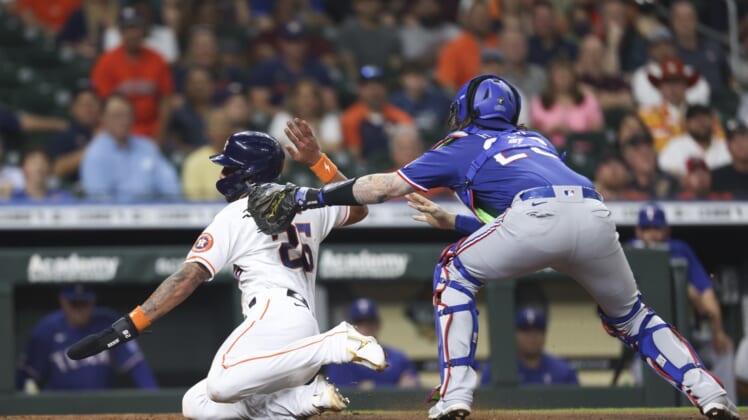 May 19, 2022; Houston, Texas, USA; Texas Rangers catcher Jonah Heim (28) tags out Houston Astros center fielder Jose Siri (26) at home plate in the second inning at Minute Maid Park. Mandatory Credit: Thomas Shea-USA TODAY Sports