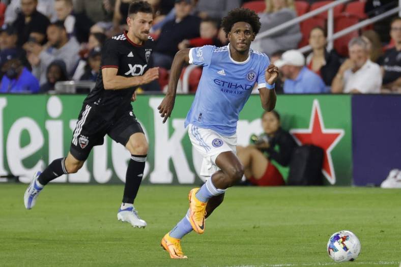 May 18, 2022; Washington, District of Columbia, USA; New York City FC forward Talles Magno (43) dribbles the ball as D.C. United defender Brendan Hines-Ike (4) chases at Audi Field. Mandatory Credit: Geoff Burke-USA TODAY Sports