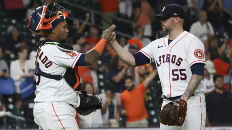 May 19, 2022; Houston, Texas, USA; Houston Astros relief pitcher Ryan Pressly (55) and catcher Martin Maldonado (15) celibrate their win against the Texas Rangers at Minute Maid Park. Mandatory Credit: Thomas Shea-USA TODAY Sports
