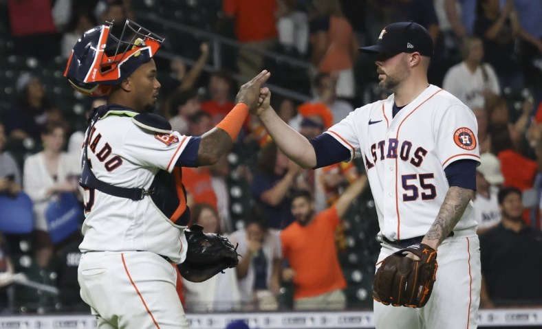 May 19, 2022; Houston, Texas, USA; Houston Astros relief pitcher Ryan Pressly (55) and catcher Martin Maldonado (15) celibrate their win against the Texas Rangers at Minute Maid Park. Mandatory Credit: Thomas Shea-USA TODAY Sports