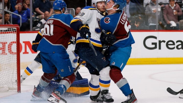 May 19, 2022; Denver, Colorado, USA; St. Louis Blues center Ivan Barbashev (49) collides with Colorado Avalanche left wing Artturi Lehkonen (62) as center Nazem Kadri (91) defends in the third period in game two of the second round of the 2022 Stanley Cup Playoffs at Ball Arena. Mandatory Credit: Isaiah J. Downing-USA TODAY Sports