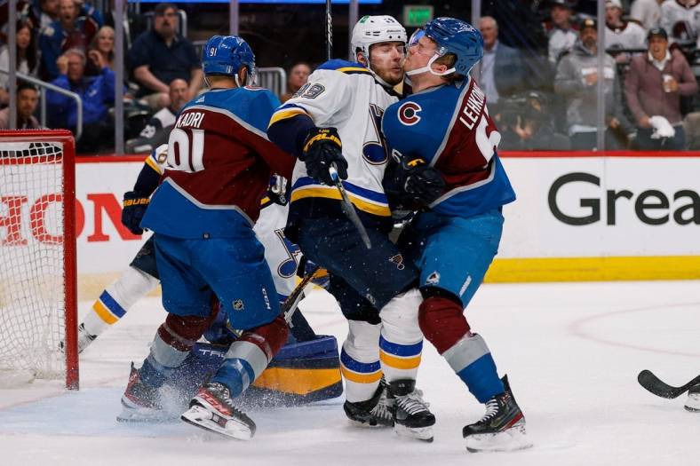 May 19, 2022; Denver, Colorado, USA; St. Louis Blues center Ivan Barbashev (49) collides with Colorado Avalanche left wing Artturi Lehkonen (62) as center Nazem Kadri (91) defends in the third period in game two of the second round of the 2022 Stanley Cup Playoffs at Ball Arena. Mandatory Credit: Isaiah J. Downing-USA TODAY Sports