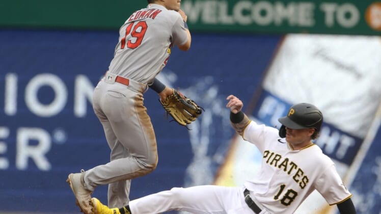 May 20, 2022; Pittsburgh, Pennsylvania, USA; St. Louis Cardinals shortstop Tommy Edman (19) turns a double play over Pittsburgh Pirates left fielder Ben Gamel (18) during the first inning at PNC Park. Mandatory Credit: Charles LeClaire-USA TODAY Sports