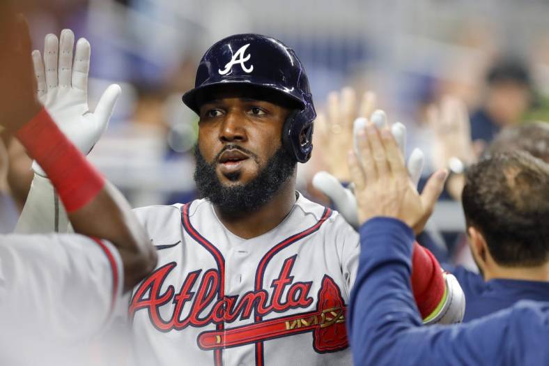 May 20, 2022; Miami, Florida, USA; Atlanta Braves left fielder Marcell Ozuna (20) celebrates with teammates after hitting a home run during the first inning against the Miami Marlins at loanDepot Park. Mandatory Credit: Sam Navarro-USA TODAY Sports