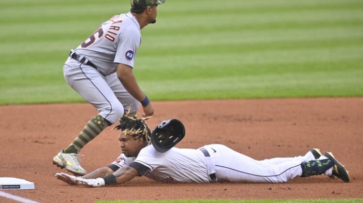 May 20, 2022; Cleveland, Ohio, USA; Cleveland Guardians third baseman Jose Ramirez (11) slides into third base for a triple as Detroit Tigers third baseman Jeimer Candelario (46) covers in the first inning at Progressive Field. Mandatory Credit: David Richard-USA TODAY Sports