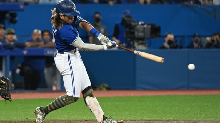 May 20, 2022; Toronto, Ontario, CAN; Toronto Blue Jays shortstop Bo Bichette (11) hits an RBI double against the Cincinnati Reds in the fifth inning at Rogers Centre. Mandatory Credit: Dan Hamilton-USA TODAY Sports