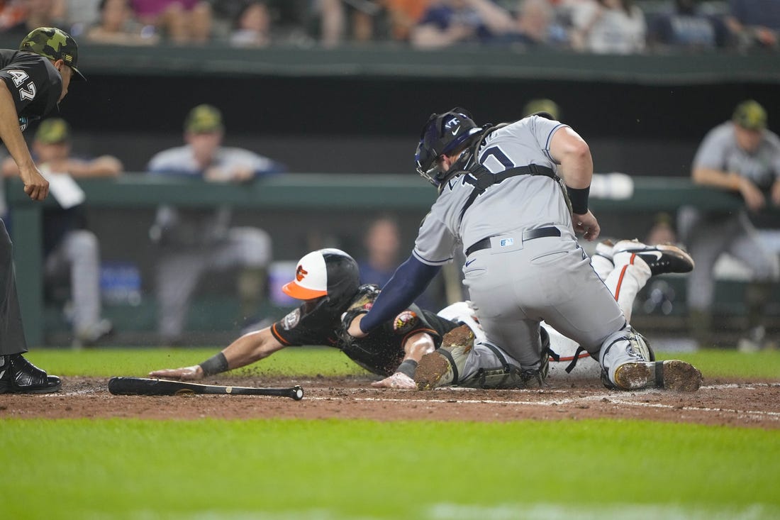 May 20, 2022; Baltimore, Maryland, USA; Tampa Bay Rays catcher Mike Zunino (10) tags out Baltimore Orioles second baseman Chris Owings (11) attempting to score a run on Baltimore Orioles center fielder Cedric Mullins (not pictured) single during the fifth inning at Oriole Park at Camden Yards. Mandatory Credit: Gregory Fisher-USA TODAY Sports