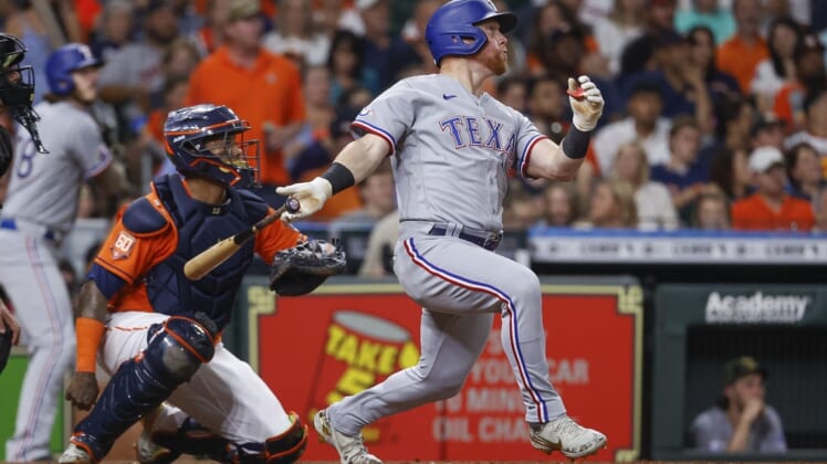 May 20, 2022; Houston, Texas, USA; Texas Rangers right fielder Kole Calhoun (56) hits a home run during the fourth inning against the Houston Astros at Minute Maid Park. Mandatory Credit: Troy Taormina-USA TODAY Sports