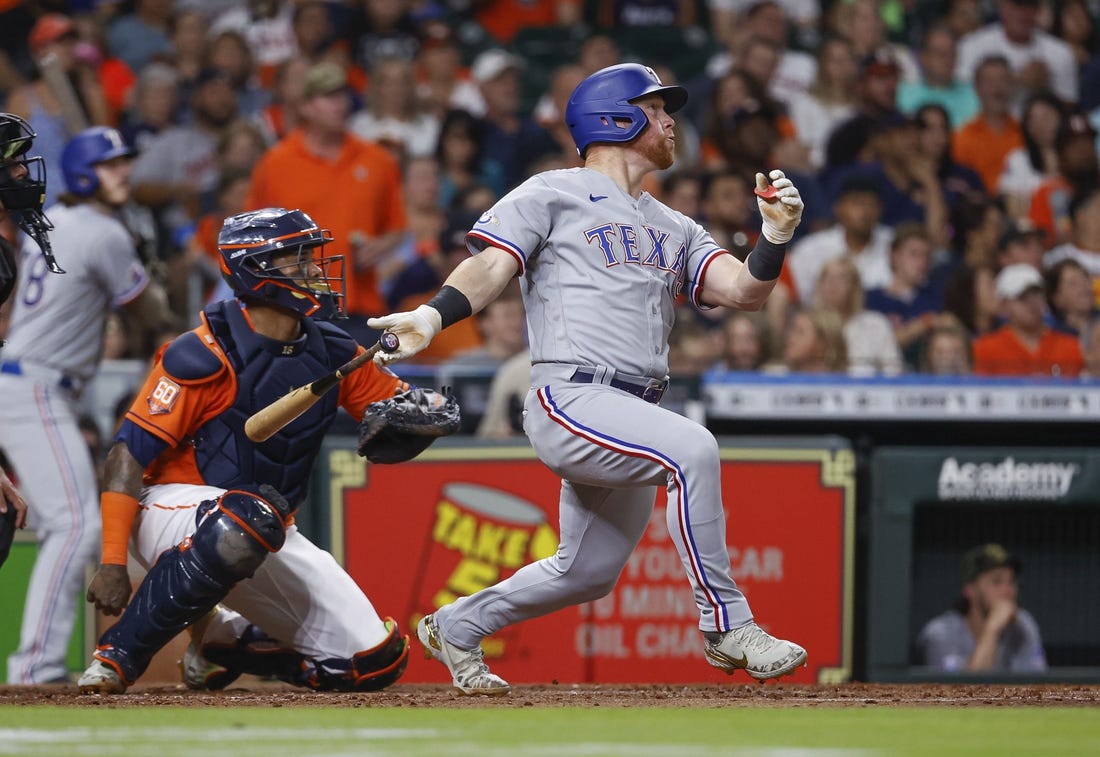 May 20, 2022; Houston, Texas, USA; Texas Rangers right fielder Kole Calhoun (56) hits a home run during the fourth inning against the Houston Astros at Minute Maid Park. Mandatory Credit: Troy Taormina-USA TODAY Sports