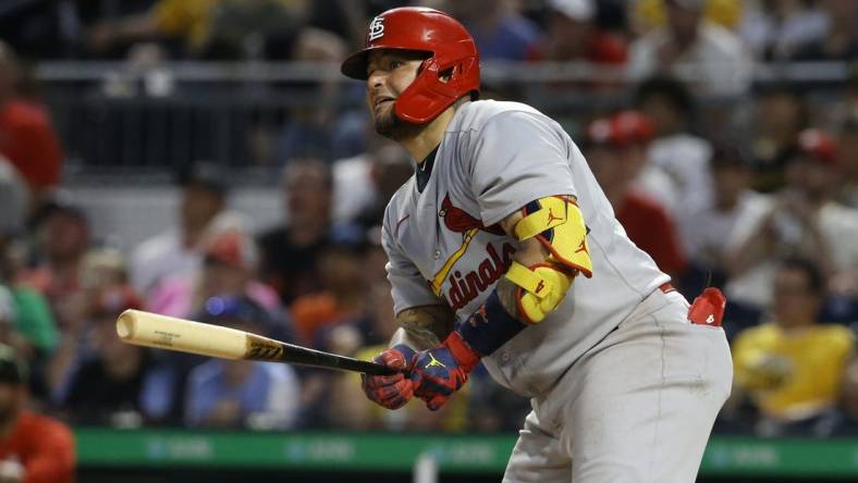 May 20, 2022; Pittsburgh, Pennsylvania, USA;  St. Louis Cardinals catcher Yadier Molina (4) hits a two-run single against the Pittsburgh Pirates during the sixth inning at PNC Park. Mandatory Credit: Charles LeClaire-USA TODAY Sports