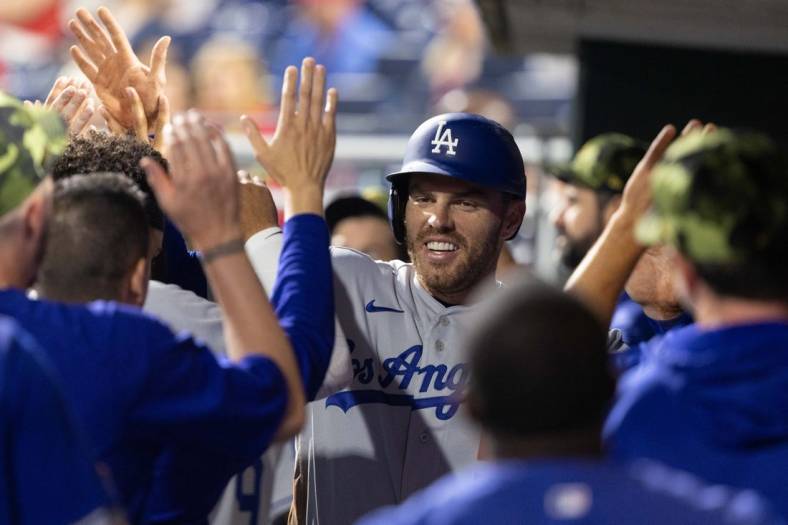 May 20, 2022; Philadelphia, Pennsylvania, USA; Los Angeles Dodgers first baseman Freddie Freeman (5) celebrates in the dugout after scoring against the Philadelphia Phillies during the ninth inning at Citizens Bank Park. Mandatory Credit: Bill Streicher-USA TODAY Sports