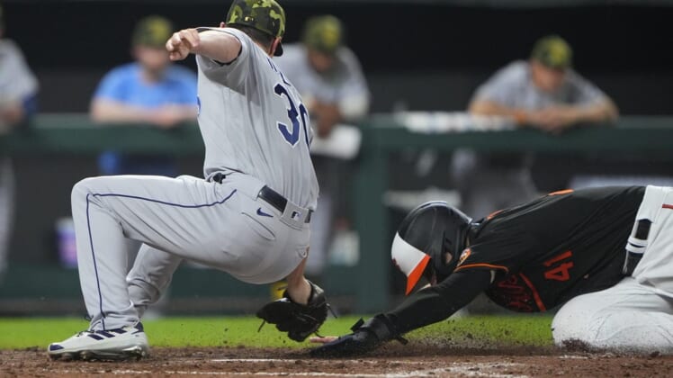 May 20, 2022; Baltimore, Maryland, USA; Baltimore Orioles first baseman Tyler Nevin (41) scores a run ahead of Tampa Bay Rays pitcher Brooks Raley (30) tag after he made a wild pitch during the seventh inning at Oriole Park at Camden Yards. Mandatory Credit: Gregory Fisher-USA TODAY Sports